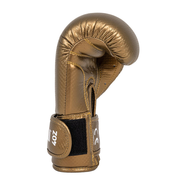 A single gold SMAI Essentials Kids Boxing Glove with a black velcro strap stands upright against a white background.
