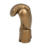 The SMAI Essentials Kids Boxing Glove in gold stands upright against a plain white background, featuring a shiny synthetic finish—making it a stylish choice for kids’ boxing gear.