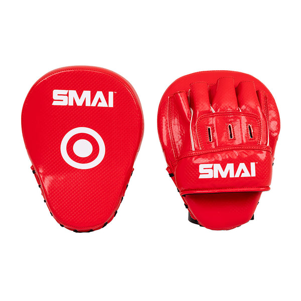 Two red Essentials Boxing Mitts by SMAI; one mitt features a circular target, the other displays finger slots and detailed stitching.