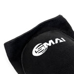 Close-up of the SMAI Padded Knee Guard - Extra Small in black, featuring a white logo, textured surface, and detailed stitching—ideal for judo and martial arts.