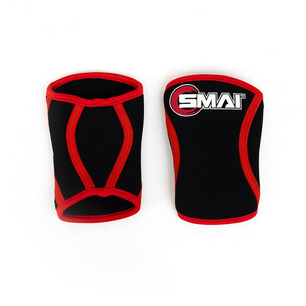 A pair of small knee sleeves by No Sync To Channel Engine, designed with black neoprene, red trim, and a contoured fit. The "SMAI" logo and visible stitching complement their support for powerlifting. Set on a plain white backdrop, they're ideal for lifters seeking added support.