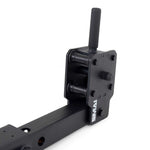 A close-up of a black metal hitch mount reveals adjustment pins and a cylindrical handle. This mount, designed by "No Sync To Channel Engine," is paired with X-Frame - Jammer Arms for increased versatility. Its robust, industrial design makes it perfect for towing or heavy-duty equipment.