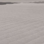 A close-up of the textured surface of the SMAI Jigsaw EVA Mat - Value Range - 3cm, showing its light color and diagonal ridges that highlight the detailed pattern and premium quality of this gym flooring from SMAI.