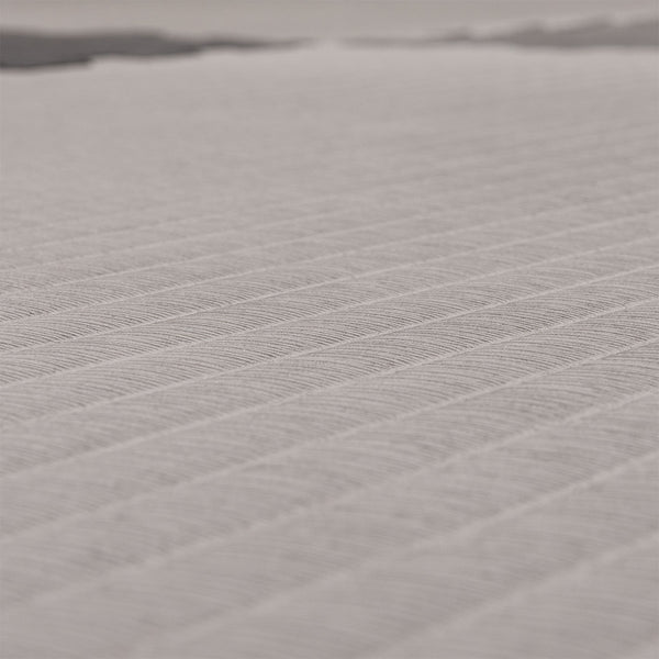 A close-up of the textured surface of the SMAI Jigsaw EVA Mat - Value Range - 3cm, showing its light color and diagonal ridges that highlight the detailed pattern and premium quality of this gym flooring from SMAI.