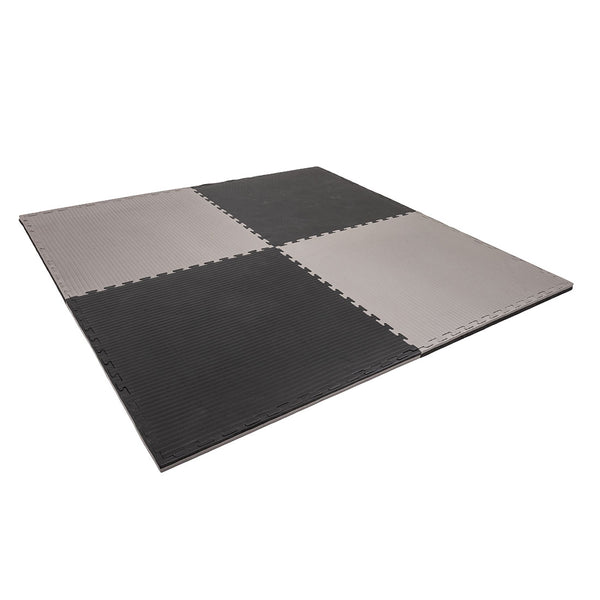 The SMAI Jigsaw EVA Mat - Value Range - 3cm features interlocking black and gray tiles with a ribbed texture, ideal for gym flooring or play areas.