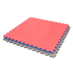 Three SMAI Jigsaw EVA Mats - Value Range - 3cm in red, blue, and gray are stacked together, displaying their interlocking puzzle edges. These mats are perfect for martial arts flooring and stand out against a clean white background.