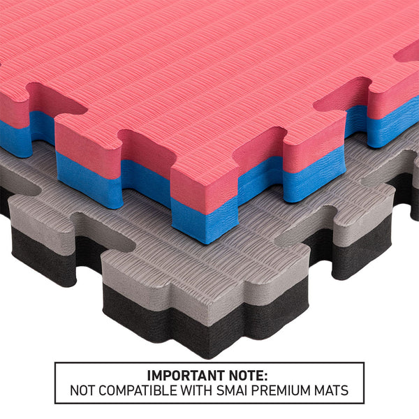 Three SMAI Jigsaw EVA Mats from the Value Range, in red/blue and gray/black, are stacked together. A label underneath states: “IMPORTANT NOTE: NOT COMPATIBLE WITH SMAI PREMIUM MATS.” These 4cm thick EVA foam mats by SMAI offer a safe and durable flooring solution, ideal for martial arts training areas.