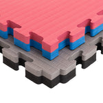 The SMAI Jigsaw EVA Mat - Value Range - 4cm features interlocking foam tiles with textured surfaces in pink, blue, gray, and black—perfect for gym flooring or play areas.