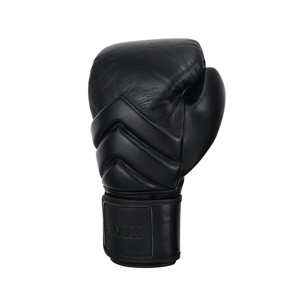 The SMAI Memory Tec Leather Boxing Glove - Black is displayed upright on a white background, showcasing its front and wrist strap with subtle stitching details.