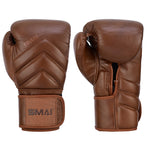 The SMAI Memory Tec Leather Boxing Glove in Antique Brown, made of premium cowhide, features padded knuckles, wrist straps, and the embossed SMAI logo—shown with one glove palm up and one palm down.