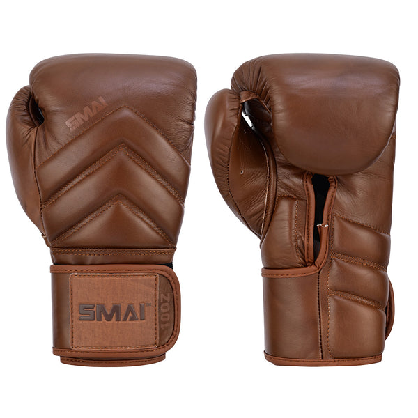 The SMAI Memory Tec Leather Boxing Glove in Antique Brown, made of premium cowhide, features padded knuckles, wrist straps, and the embossed SMAI logo—shown with one glove palm up and one palm down.