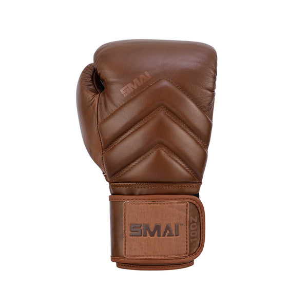 The SMAI Memory Tec Leather Boxing Glove in Antique Brown features chevron stitching, a Velcro strap, and Memory Tech foam for comfort. The glove stands upright against a white background with visible "SMAI" branding.