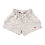 SMAI Muay Thai Shorts - Grey: unisex, slightly shiny satin polyester with a high elastic waistband and black, red, and white SMAI logo on the waistband and lower left leg.