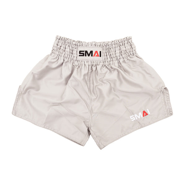 SMAI Muay Thai Shorts - Grey: unisex, slightly shiny satin polyester with a high elastic waistband and black, red, and white SMAI logo on the waistband and lower left leg.
