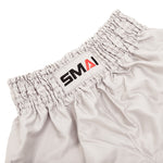Close-up of the elastic waistband on SMAI’s Muay Thai Shorts - Grey, featuring a sewn-on white patch with the brand name "SMAI" in black and red letters.
