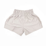 The SMAI Muay Thai Shorts - Grey, made from satin polyester, feature a high, wide elastic waistband. Displayed flat on a white background, these unisex shorts show the back and a relaxed fit.