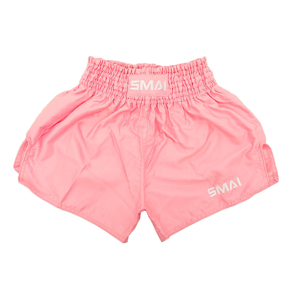 SMAI Muay Thai Shorts - Pink: Unisex satin polyester shorts with a wide elastic waistband and “SMAI” in white on the waistband and left leg, shown on a white background.