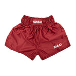 SMAI Muay Thai Shorts - Red feature a shiny quick-dry satin finish, elastic waistband, and white SMAI logo on the waistband and lower left leg. Unisex design offers a loose fit for comfort.