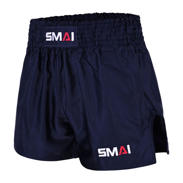 Introducing the SMAI Muay Thai Shorts - Navy: these unisex shorts feature a high elastic waistband and classic side slit, designed in the traditional Muay Thai style. The brand “SMAI” is prominently displayed in white and red on both the waistband and the lower left leg, making them an ideal choice for training or competition.