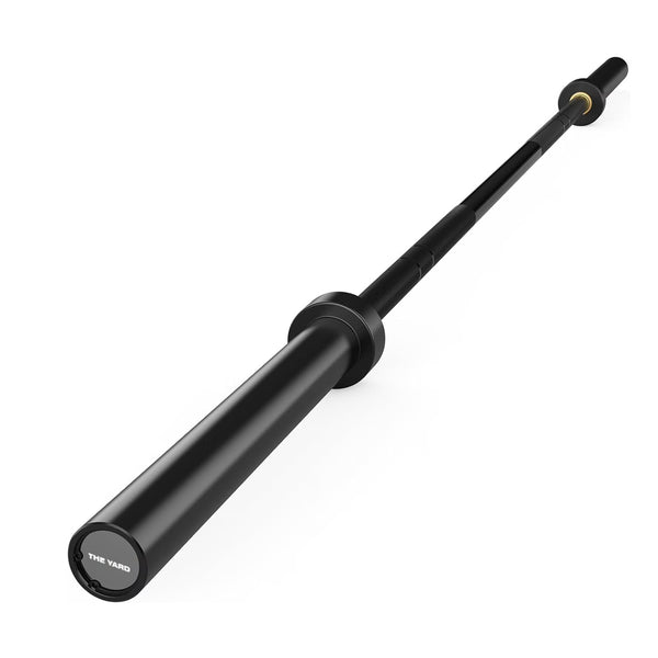 A black 20kg SMAI The Yard barbell, made from durable alloy steel with branded end cap, is shown angled on a plain white background.
