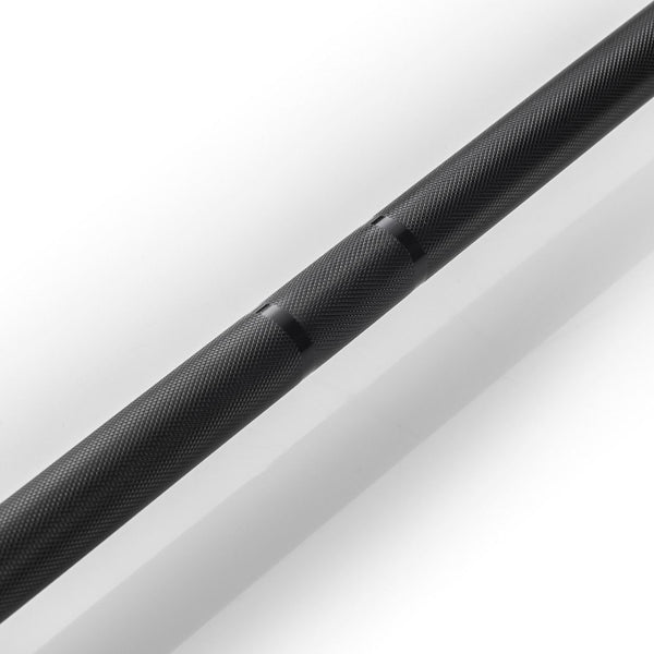 Close-up of the SMAI The Yard - Barbell - 20kg in black, featuring a textured alloy steel handle with knurled grip markings, photographed on a white background.