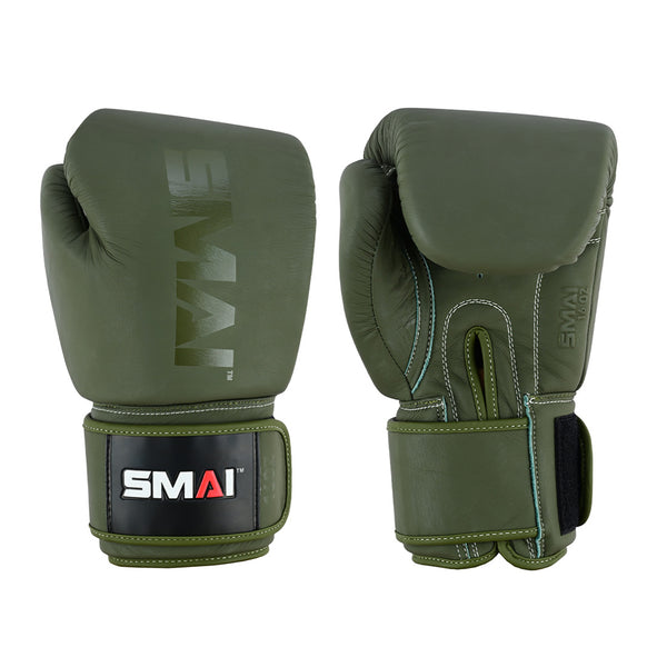 The SMAI Elite85 Boxing Glove in olive green leather features white stitching and black wrist straps with a red, white, and gray "SMAI" logo patch. Both the palm and back are shown side by side for injury reduction.