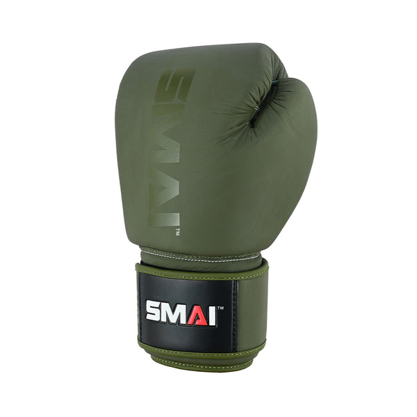 The Elite85 Boxing Glove by SMAI in olive green features injection-moulded padding for injury reduction, "SMAI" branding on top, and a black wrist strap with SMAI’s logo. The glove is shown against a plain white background.