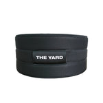 The SMAI The Yard - Nylon Weightlifting Belt - Large is a black adjustable belt with "THE YARD" in white on a front patch, designed for lower back support and shown on a plain white background.