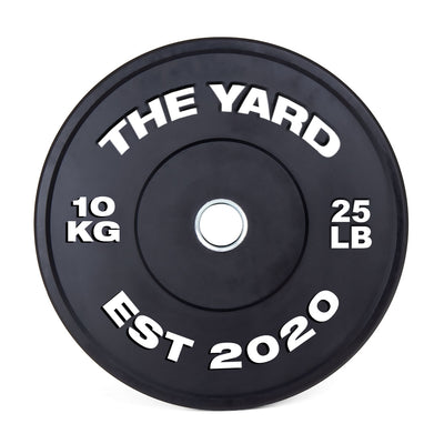 The SMAI The Yard - HD Bumper Plates (Pair) - 10kg are black, marked with "THE YARD" and "EST 2020" in white. Made from high-density virgin rubber, each plate shows "10 KG" left and "25 LB" right—perfect for any home gym.