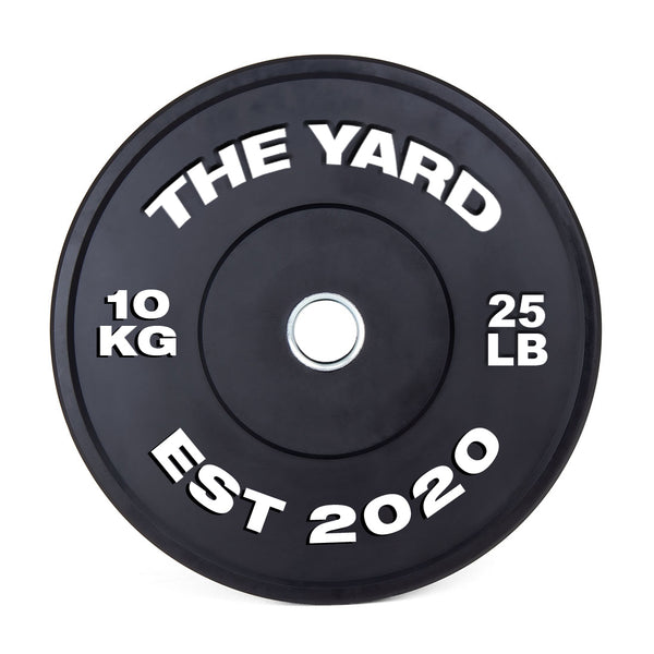The SMAI The Yard - HD Bumper Plates (Pair) - 10kg are black, marked with "THE YARD" and "EST 2020" in white. Made from high-density virgin rubber, each plate shows "10 KG" left and "25 LB" right—perfect for any home gym.