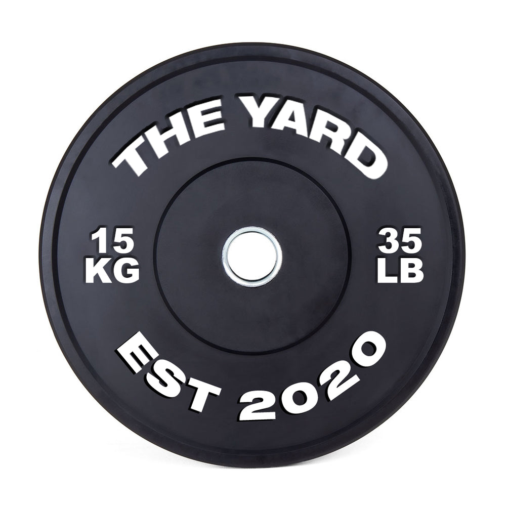 The Yard - HD Bumper Plates (Pair) - 15kg by SMAI: Black, made from high-density virgin rubber, with white "THE YARD" text, “15 KG,” “35 LB,” and “EST 2020.” Metallic center hole—perfect for any home gym.