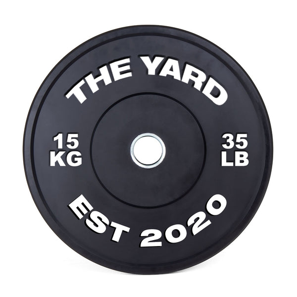 The Yard - HD Bumper Plates (Pair) - 15kg by SMAI: Black, made from high-density virgin rubber, with white "THE YARD" text, “15 KG,” “35 LB,” and “EST 2020.” Metallic center hole—perfect for any home gym.