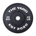 The SMAI The Yard - HD Bumper Plates (Pair) - 20kg feature high-density virgin rubber, bold white "THE YARD," "20 KG," "45 LB," and "EST 2020" markings, plus a silver center ring—ideal for any home gym.