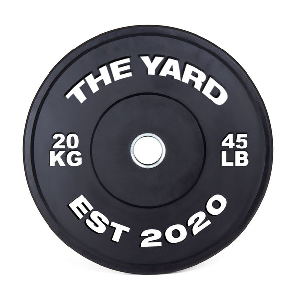 The SMAI The Yard - HD Bumper Plates (Pair) - 20kg feature high-density virgin rubber, bold white "THE YARD," "20 KG," "45 LB," and "EST 2020" markings, plus a silver center ring—ideal for any home gym.