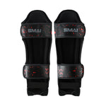The SMAI Muay Thai Shin Instep Guard - Black Dragon features a red splatter design, adjustable straps, and protective padding—perfect for style and reliable protection in Muay Thai.