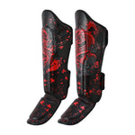 The SMAI Muay Thai Shin Instep Guard - Black Dragon features red and gray dragon designs, splatter patterns, padded instep protection, adjustable straps, and durable synthetic leather—ideal for intense training sessions.