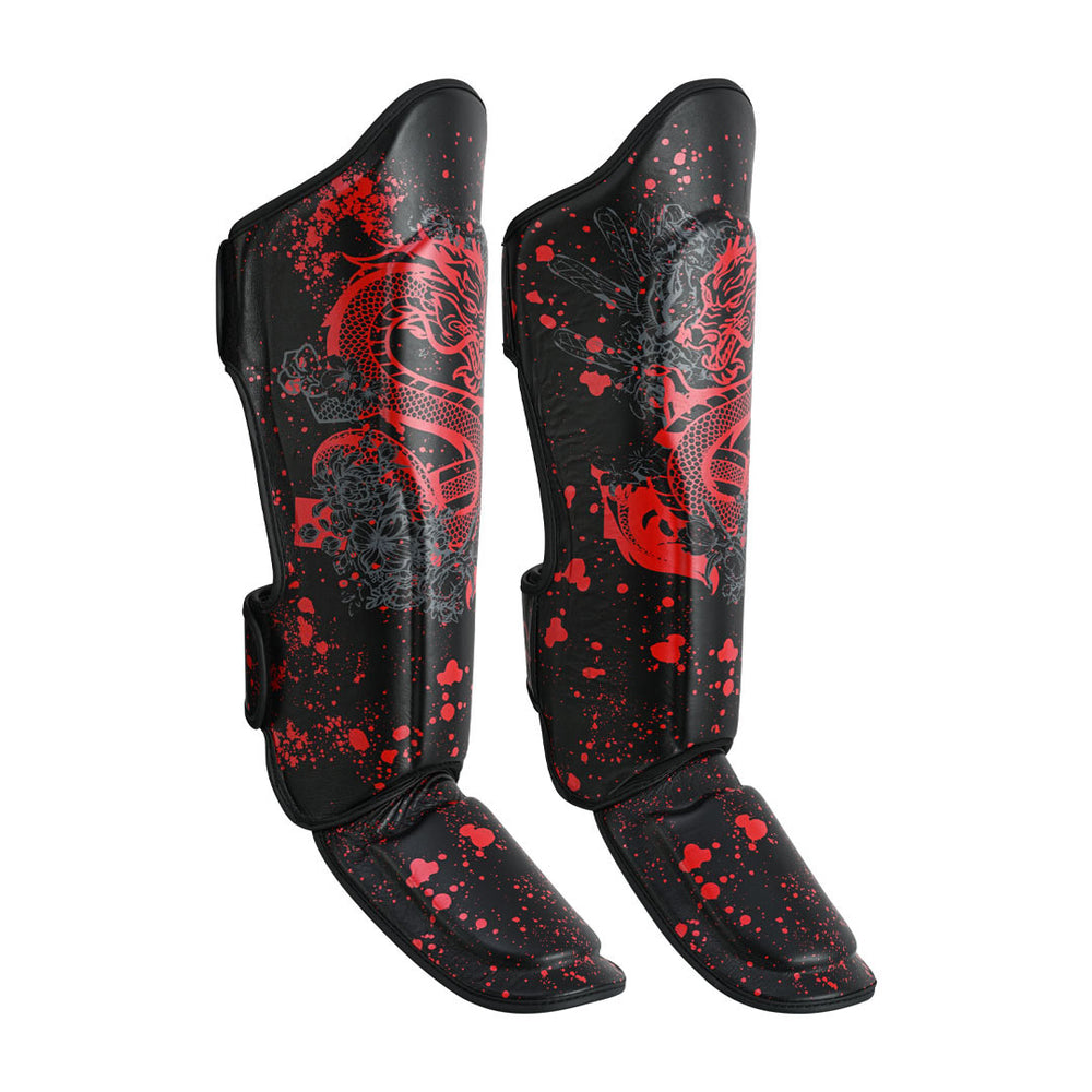 The SMAI Muay Thai Shin Instep Guard - Black Dragon features bold red dragon and splatter designs, with separated shin and foot protection for safety and style during tough training sessions.