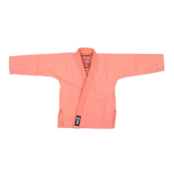 The SMAI Supreme X Brazilian Jiu Jitsu Uniform - Salmon features a pearl weave jacket with collar and long sleeves, shown flat on a white background. A label and black patch highlight the branding—ideal for youth martial arts training.