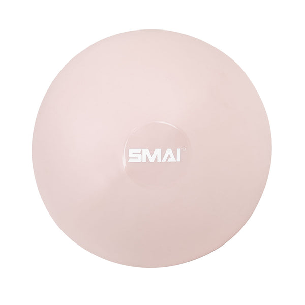 The SMAI Pilates Ball - Clay Pink is a pale pink, round ball with a white "SMAI" logo at the center, shown from above on a white background—perfect for core strengthening and Pilates workouts.