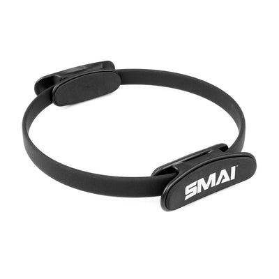 The SMAI Pilates Ring / Yoga Ring - Commercial Grade features cushioned handles on both sides for resistance training. The black ring displays the white SMAI logo on one handle and is shown against a clean white background.