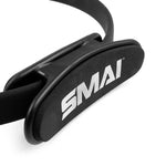 Close-up of a black SMAI Pilates Ring / Yoga Ring with padded section labeled "SMAI" in white, made with foam and plastic for resistance training. Commercial grade quality.