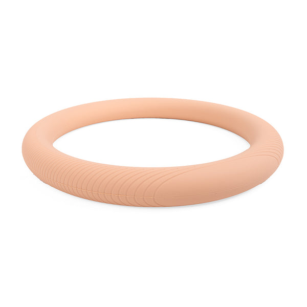 The SMAI Pilates Power Ring Blush Pink 4.5kg features a subtle ridged texture on one side and lies flat on a white background, making it perfect for Pilates strength training.