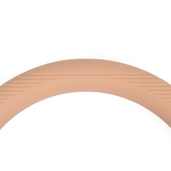 A close-up of the SMAI Pilates Power Ring Blush Pink 4.5kg, featuring a light brown silicone cover with the brand name "SMAI" embossed, set against a white background.