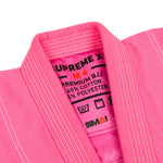 Close-up of the SMAI Supreme X Brazilian Jiu Jitsu Uniform in pink, with pearl weave fabric and an inner collar label showing size M4, fabric details, care instructions, and the brand name.