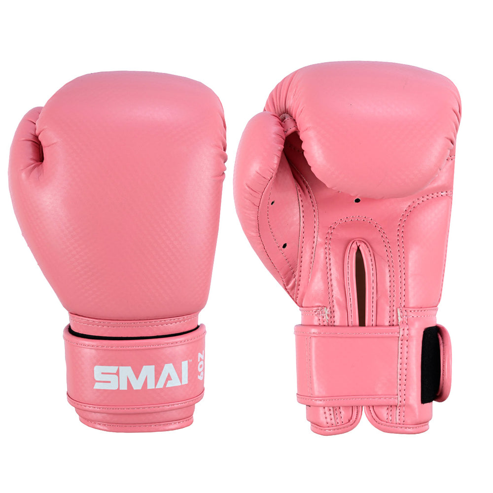 The SMAI Essentials Kids Boxing Glove in pink features Velcro straps, white “SMAI” branding, detailed stitching, and ventilation holes for comfort and support—perfect gloves for young boxers.