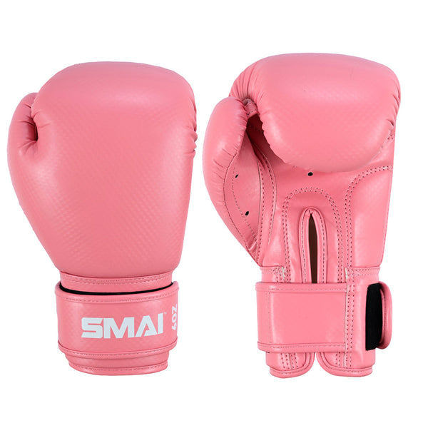 The SMAI Essentials Kids Boxing Glove in pink features Velcro straps, white “SMAI” branding, detailed stitching, and ventilation holes for comfort and support—perfect gloves for young boxers.