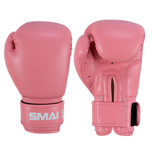 The PRE ORDER: Essentials Kids Boxing Glove - Pink by SMAI is shown, one palm up and one down. Made from synthetic leather, they have padded knuckles, wrist straps for support, and "SMAI" printed in white on the wrist.