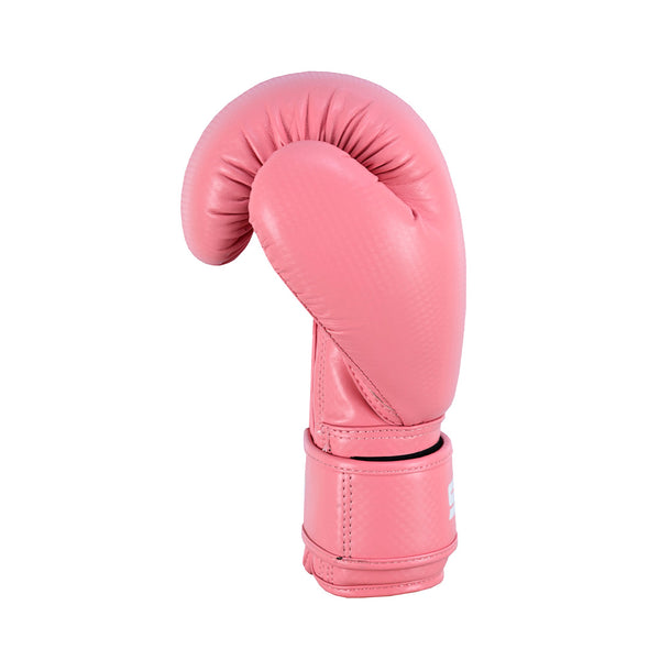 The SMAI Essentials Kids Boxing Glove in pink stands upright against a white background, showcasing its curved design and secure wrist strap—ideal for young boxers.