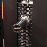 Close-up of a SMAI Weight Stack Extender Pin inserted into a cable machine weight stack, showing numbers for different weight levels and the SMAI brand on the pin.