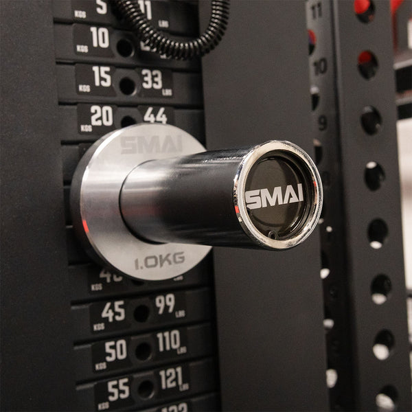 Close-up of a SMAI Weight Stack Extender Pin for Cable Machine mounted on a weight stack, displaying weight numbers in kilograms and pounds.